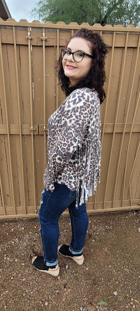 Leopard print top with v-neckline, long sleeves and fringe back. This cute shirt adds a little sass to your life. "Fringe With Benefits" is very unique, so you will not find another one like it! Go ahead and put your boots on! Go dancing, or to the rodeo, wear this cutie for any reason, or no reason at all. Strut your stuff! Sizes small through large.