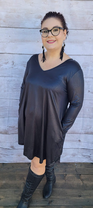 This dress is a shiny metallic faux leather. "Nobody's Angel" dress in knee length that features long sleeves, pockets, v-neck and v-back. Imagine yourself going out friends, dancing, or shopping the town. You will definitely turn heads. Enjoy your self in this must have black dress. Go ahead and try something new! Maybe learn to line dance!