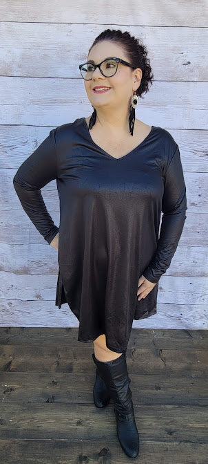 This dress is a shiny metallic faux leather. "Nobody's Angel" dress in knee length that features long sleeves, pockets, v-neck and v-back. Imagine yourself going out friends, dancing, or shopping the town. You will definitely turn heads. Enjoy your self in this must have black dress. Go ahead and try something new! Maybe learn to line dance!