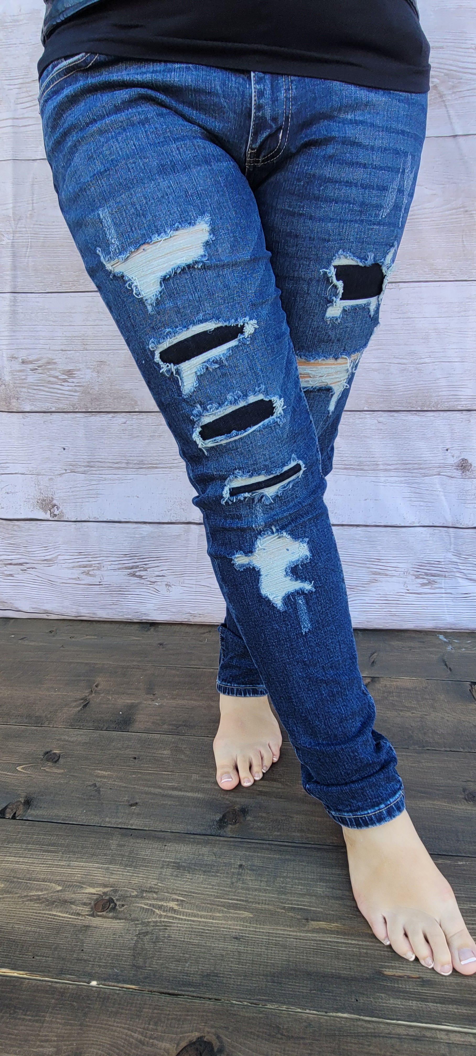 These denim jeans are dark wash, mid rise, super skinny, with distressed and ripped dark denim peekaboo patches, with a non-distressed ankle hem. "Chasing After You Denim" jeans are perfect for everyday wear.