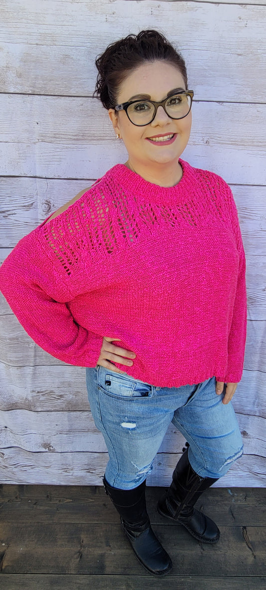 This fuchsia long sleeve knit sweater features eyelet front upper design, cold shoulder, round neck, and over sized sleeves.  This is a very comfy sweater as it is very loose fitting. Pair this sweater with your favorite jeans, denim skirt or leggings. Sizes small through large.