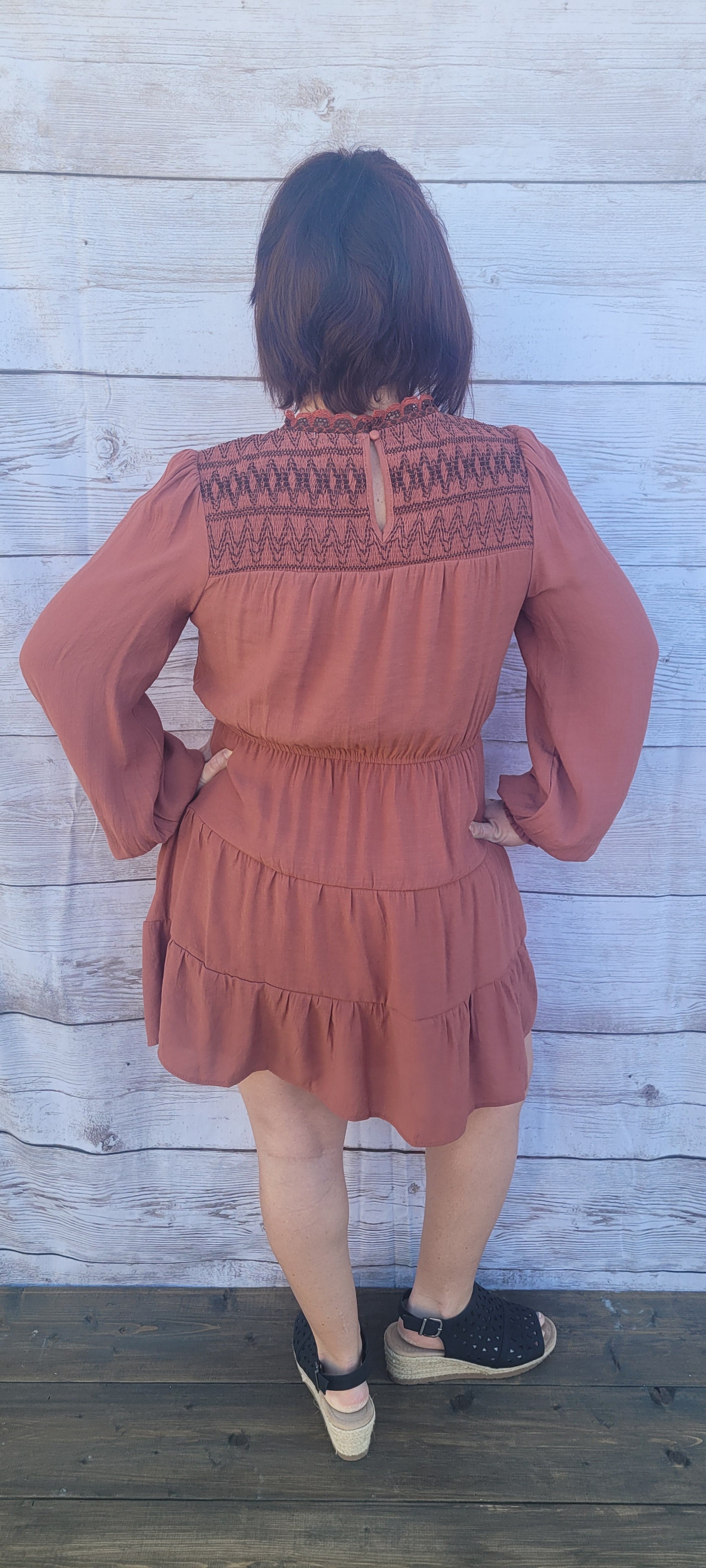 Imagine yourself going to the rodeo, hanging out with friends, or just because you want to.  This cute little number has a smocked neckline and cuffs, balloon sleeves, tiered layers, cinched waist, and button on back neckline. This is a cute and unique dress.  You will not walk down the street and see everyone else wearing this cute dress.  You be you!