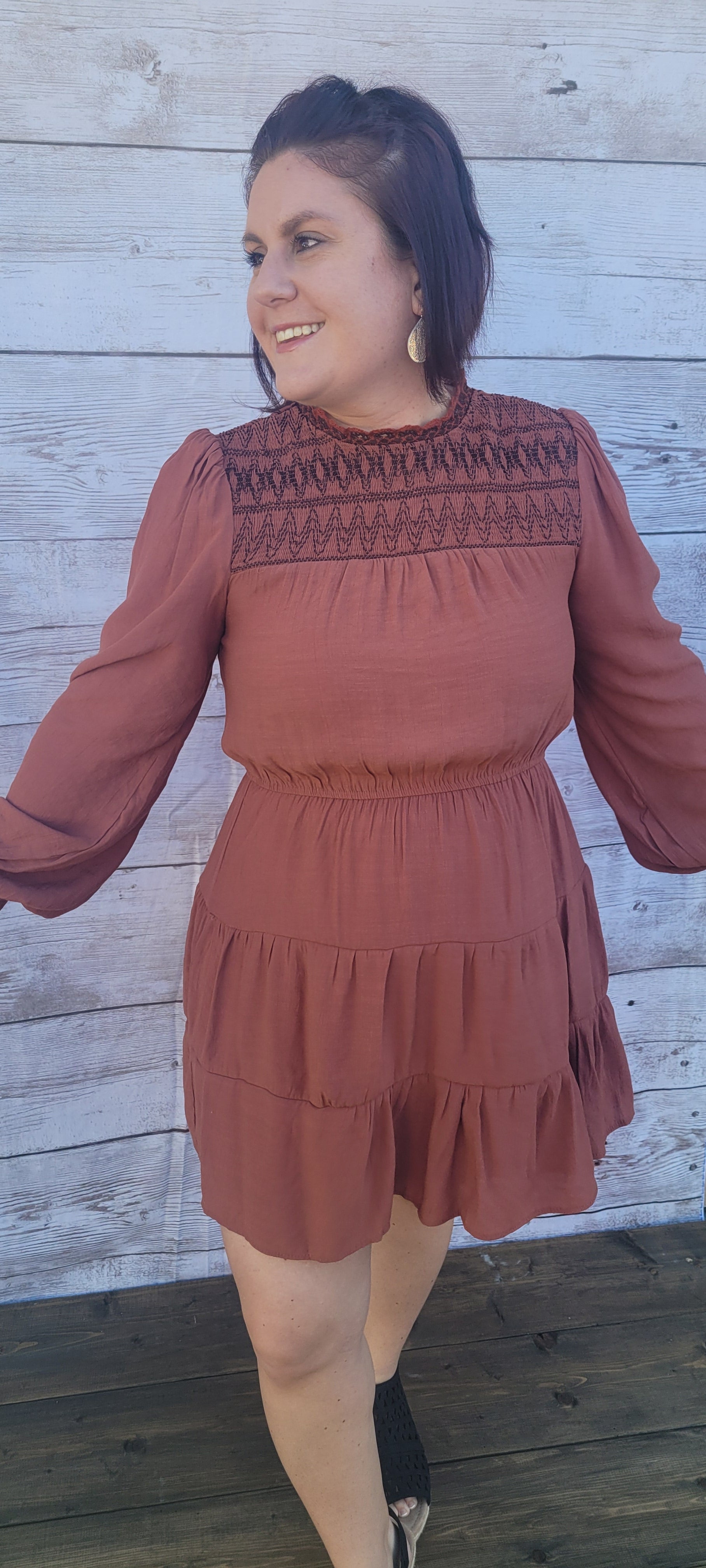 Imagine yourself going to the rodeo, hanging out with friends, or just because you want to.  This cute little number has a smocked neckline and cuffs, balloon sleeves, tiered layers, cinched waist, and button on back neckline. This is a cute and unique dress.  You will not walk down the street and see everyone else wearing this cute dress.  You be you!