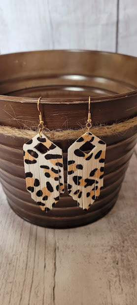 White Leopard Fringe Earrings  Elongated hexagon design Diamond cutout Genuine leather Leopard print Gold fish hook Rubber earring back Whether you want to be on the wild side or classy this earring set it will add a fun touch to your outfit