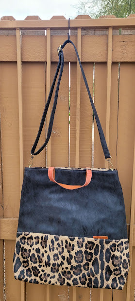 This genuine leather tote features carrying handles, removable and a adjustable shoulder strap, zipper enclosure, interior zipper pouch and pocket, and two interior slip pockets. This is a very roomy tote bag, with a place to hold your cell phone and accessories. The colors are stone washed black, camel, and leopard print. Measurements: 15.5 inch width, 5 inch depth, 17 inch length.