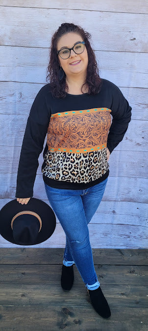 Canyon Cowgirl  Description  This is a comfy, buttery soft, heavier weight top, but not a sweatshirt. Canyon Cowgirl is a long sleeve black top, featuring blocked leopard print and western print on the front.  Pair with your favorite pair of denim jeans, shorts, or jean skirt.  Don’t be afraid to get creative! Sizes medium through x-large