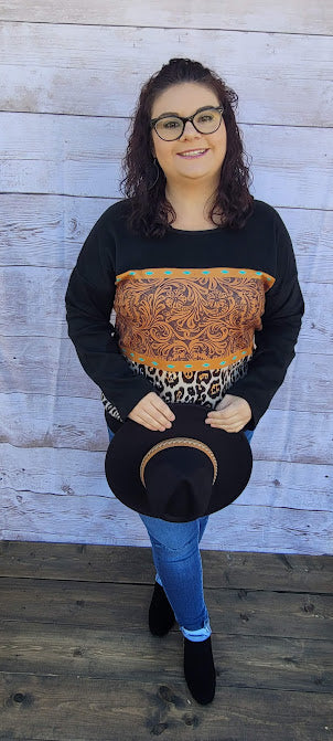 Canyon Cowgirl  Description  This is a comfy, buttery soft, heavier weight top, but not a sweatshirt. Canyon Cowgirl is a long sleeve black top, featuring blocked leopard print and western print on the front.  Pair with your favorite pair of denim jeans, shorts, or jean skirt.  Don’t be afraid to get creative! Sizes medium through x-large