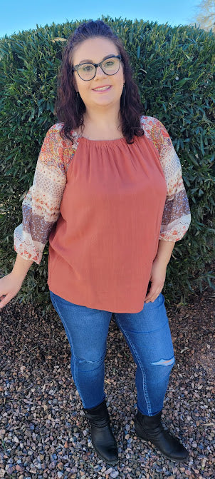 Desert Ironwood  Description  Imagine yourself riding your horse. This cutie is an off the shoulder top with an elastic neckline, shear 3/4 sleeves that offer that beautiful desert design, and is very roomy.  You can't go wrong with an off the shoulder look.  I hear this top calling your name!  Go ahead and make a statement. Sizes small through large.