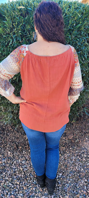 Desert Ironwood  Description  Imagine yourself riding your horse. This cutie is an off the shoulder top with an elastic neckline, shear 3/4 sleeves that offer that beautiful desert design, and is very roomy.  You can't go wrong with an off the shoulder look.  I hear this top calling your name!  Go ahead and make a statement. Sizes small through large.