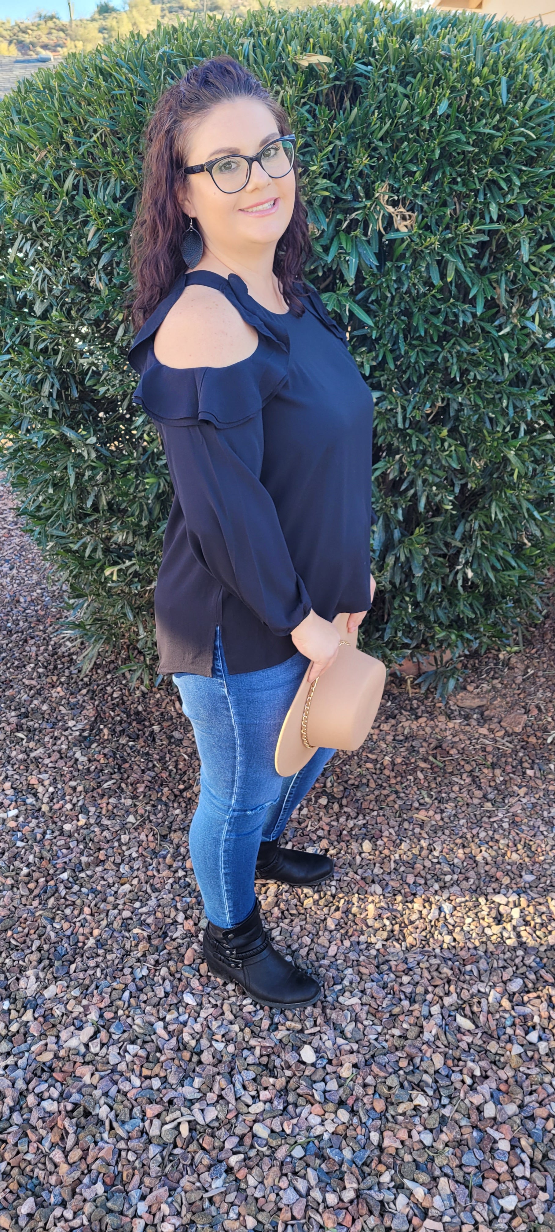 The Twilight top is a must have staple in your closet. This black top features puff sleeves, with an elastic cuff, open ruffled cold shoulder long sleeves, and rounded neckline. This top is light weight, so it can be worn in the summer, spring, fall or winter. You can dress this number up, or leave it the way it is, since it's just so darn cute.  Sizes small through large.