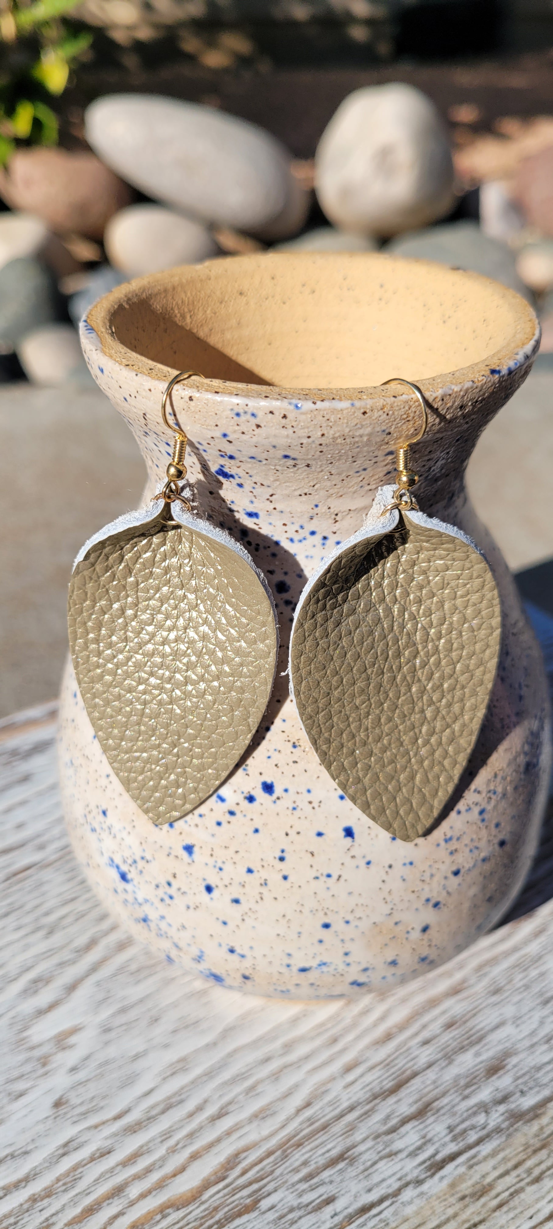 Teardrop shape Tan genuine leather Metallic gold Brushed gold fish hook dangle earrings Rubber earring back Whether you want to be on the wild side or classy this earring set it will add a fun touch to your outfit