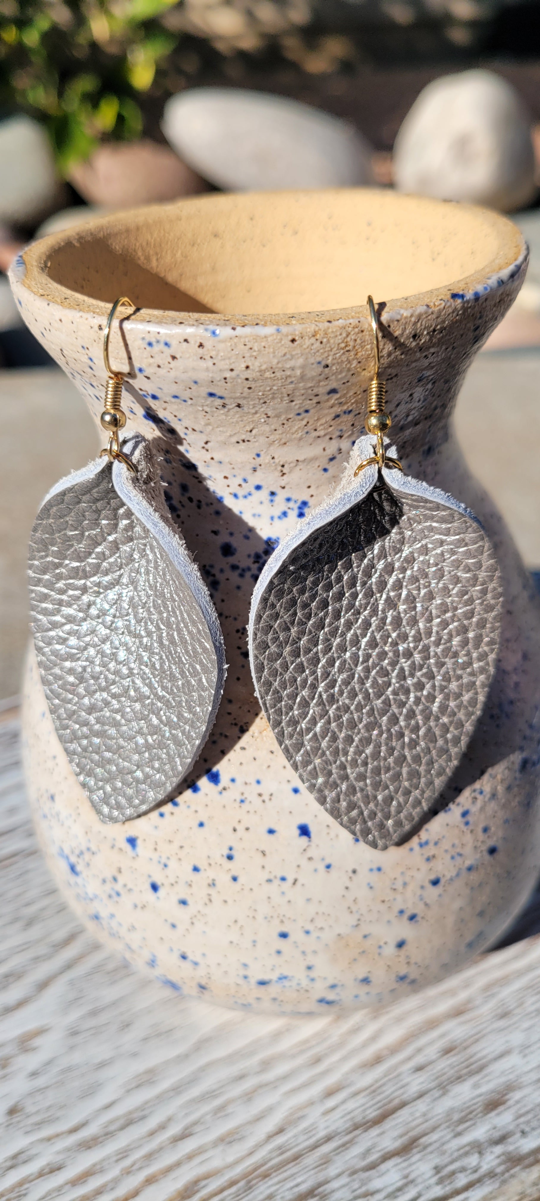Teardrop shape Gray genuine leather Metallic silver Brushed gold fish hook dangle earrings Rubber earring back Whether you want to be on the wild side or classy this earring set it will add a fun touch to your outfit