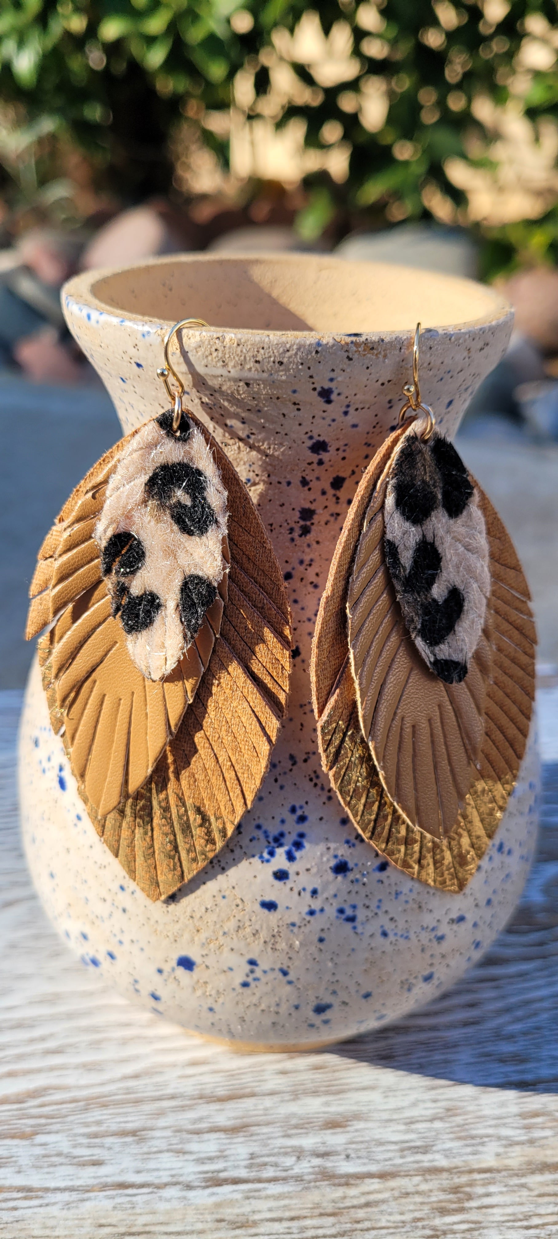 Marquise shape Faux leather Tan leopard print, camel, camel with dipped gold feather Brushed gold fish hook dangle earrings Rubber earring back Drop length 3”, width 1.25” Whether you want to be on the wild side or classy this earring set it will add a fun touch to your outfit