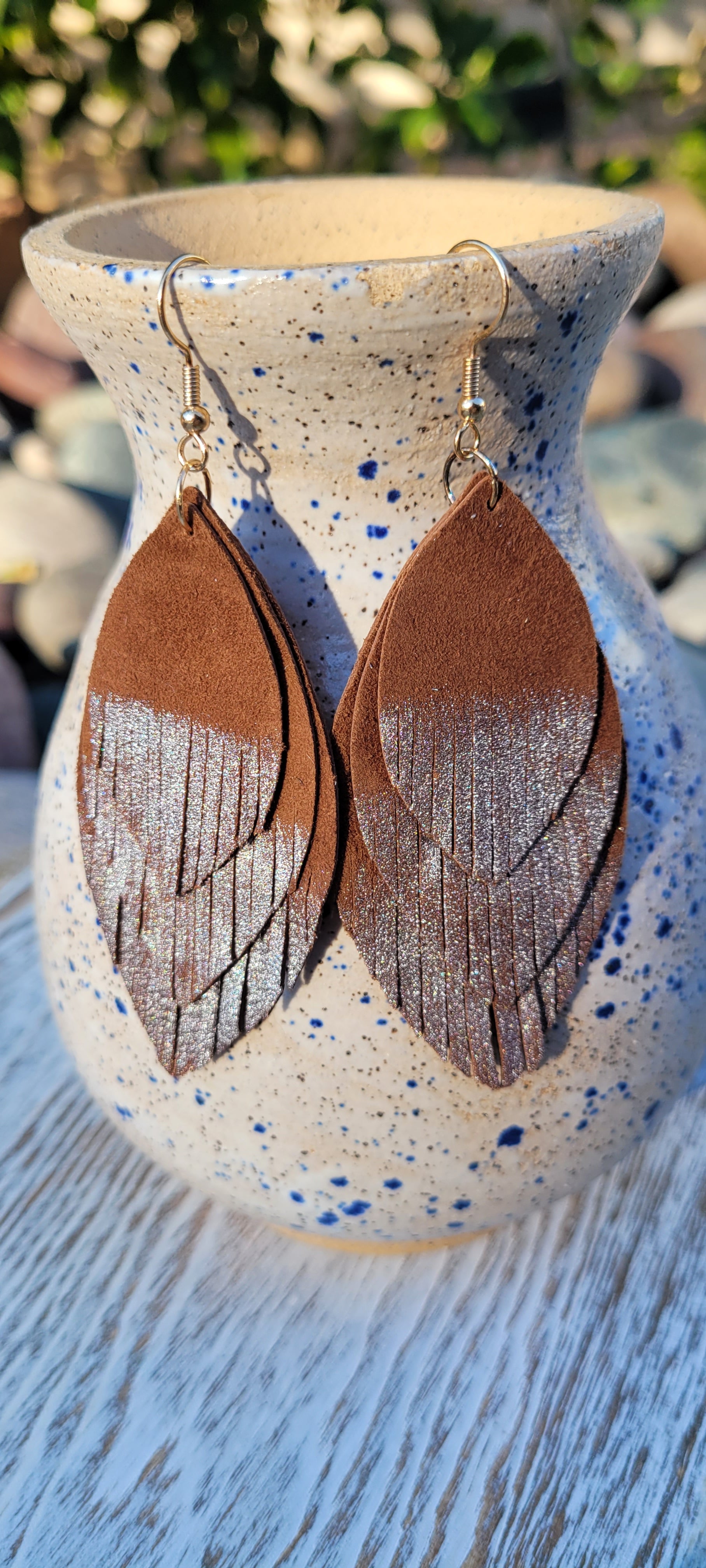 Marquise shape Genuine leather Brown leather with dipped silver fringes Brushed gold fish hook dangle earrings Rubber earring back Whether you want to be on the wild side or classy this earring set it will add a fun touch to your outfit