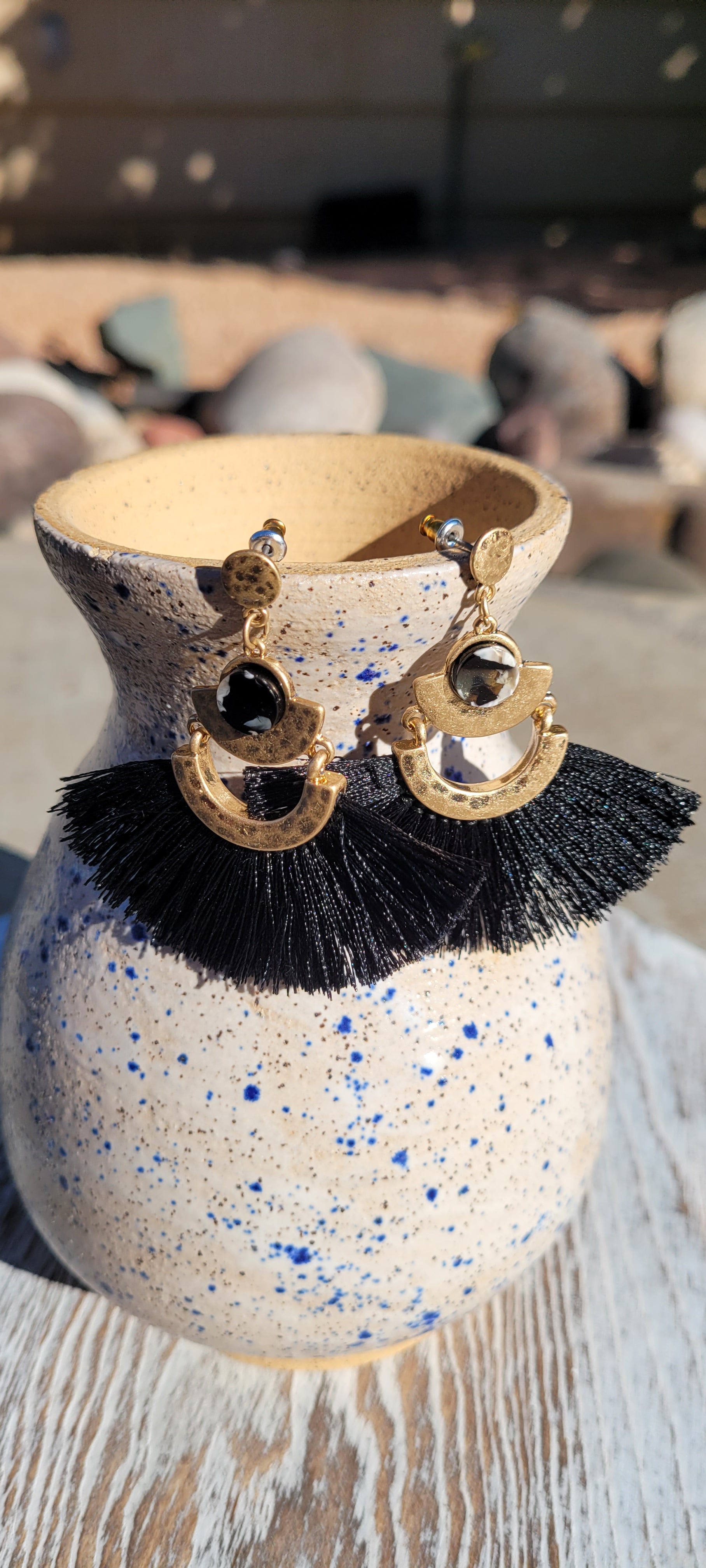 Black tassels Brushed gold dangle design Marbled jewel Brushed gold stud earrings Metal earring back Length 2”, width 2” Whether you want to be on the wild side or classy this earring set it will add a fun touch to your outfit