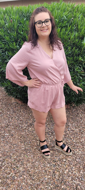 This dusty blush linen blend romper features a scallop hemmed,  elastic waistband, scallop edge around shorts, scallop neckline, with snap closure,  3/4  bell sleeves, and a drawstring with pockets. Get ready for a road trip.  See where this very cute romper takes you.  If vacation is in your future, then this is a must have.  You will feel comfortable and look oh so cute! Sizes small through large.