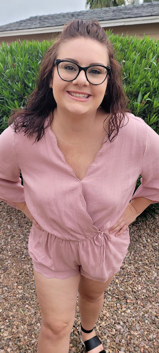This dusty blush linen blend romper features a scallop hemmed,  elastic waistband, scallop edge around shorts, scallop neckline, with snap closure,  3/4  bell sleeves, and a drawstring with pockets. Get ready for a road trip.  See where this very cute romper takes you.  If vacation is in your future, then this is a must have.  You will feel comfortable and look oh so cute! Sizes small through large.