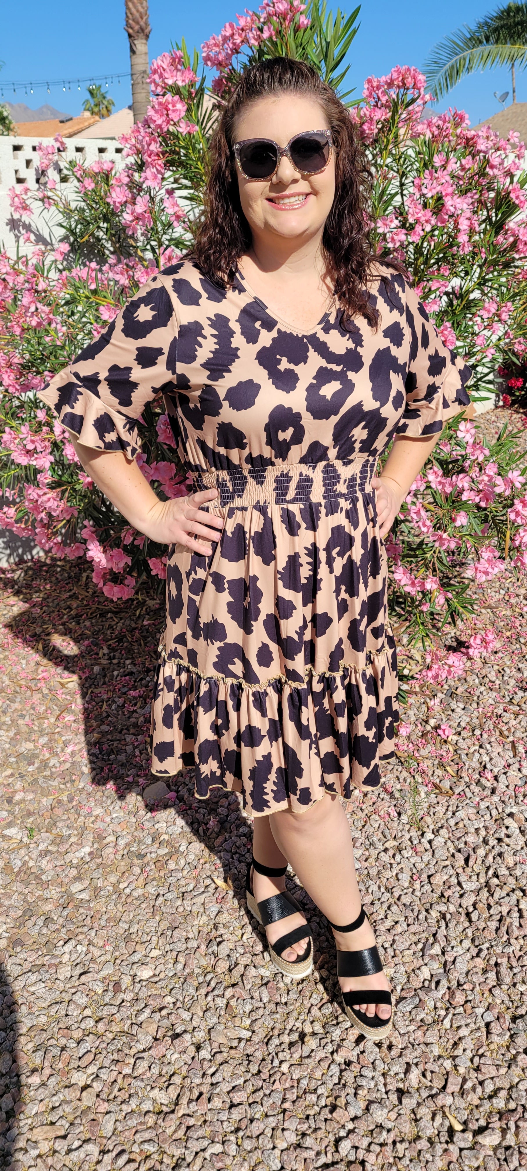 “The Wild Side” is a camel and black colored dress. This dress features a buttery soft animal print, v-neck, elastic cinched waistband, short bell sleeves with ruffles, and ruffle hemline. It sits above the knee. This dress is just as cozy as pajamas! Sizes small through large