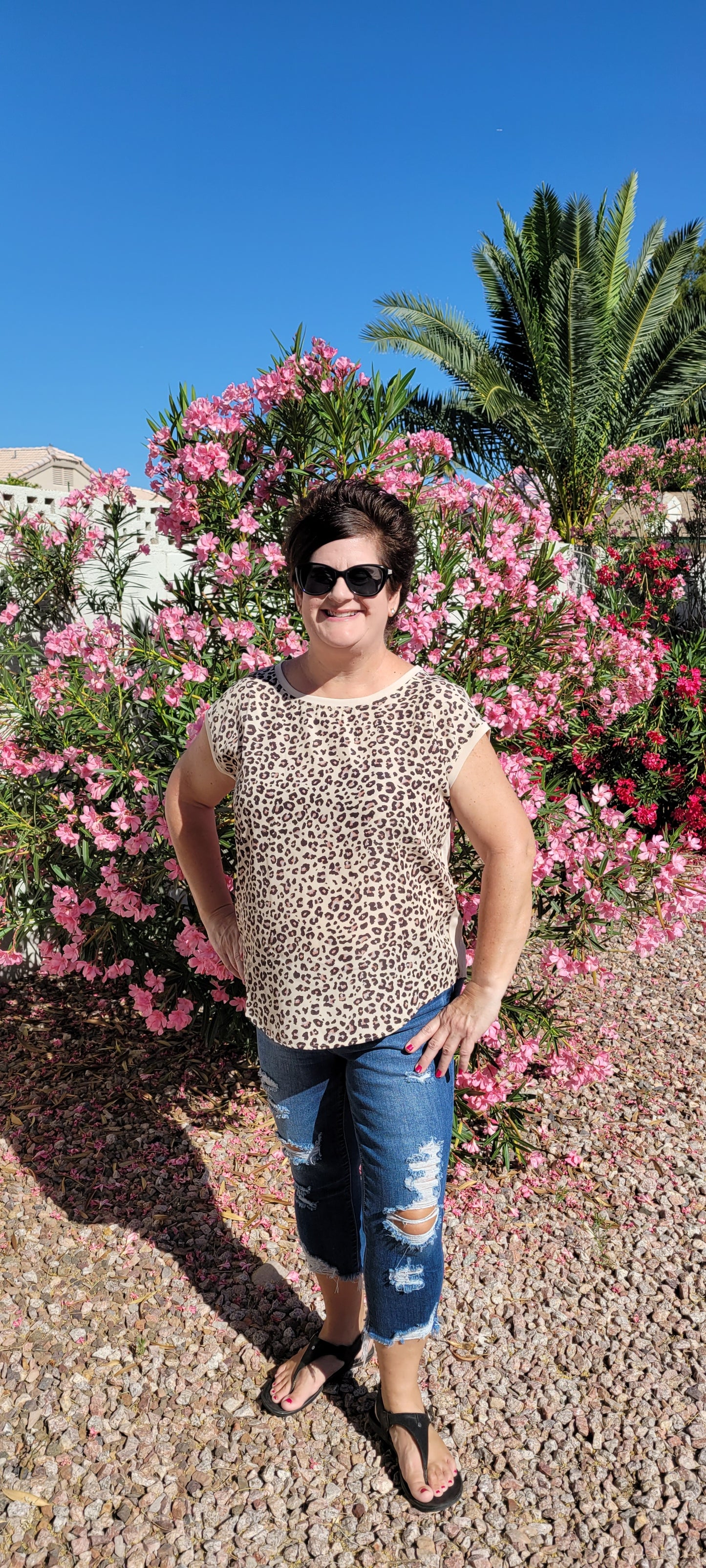 “Road Less Traveled” is a sleeveless top, with leopard print front (beige, brown, camel, agreeable gray) and contrast back, boat neckline, trimmed with beige soft modal, and rounded hemline. This is a satiny, silky soft high-low top. This is definitely a business or casual top. Sizes small through large.