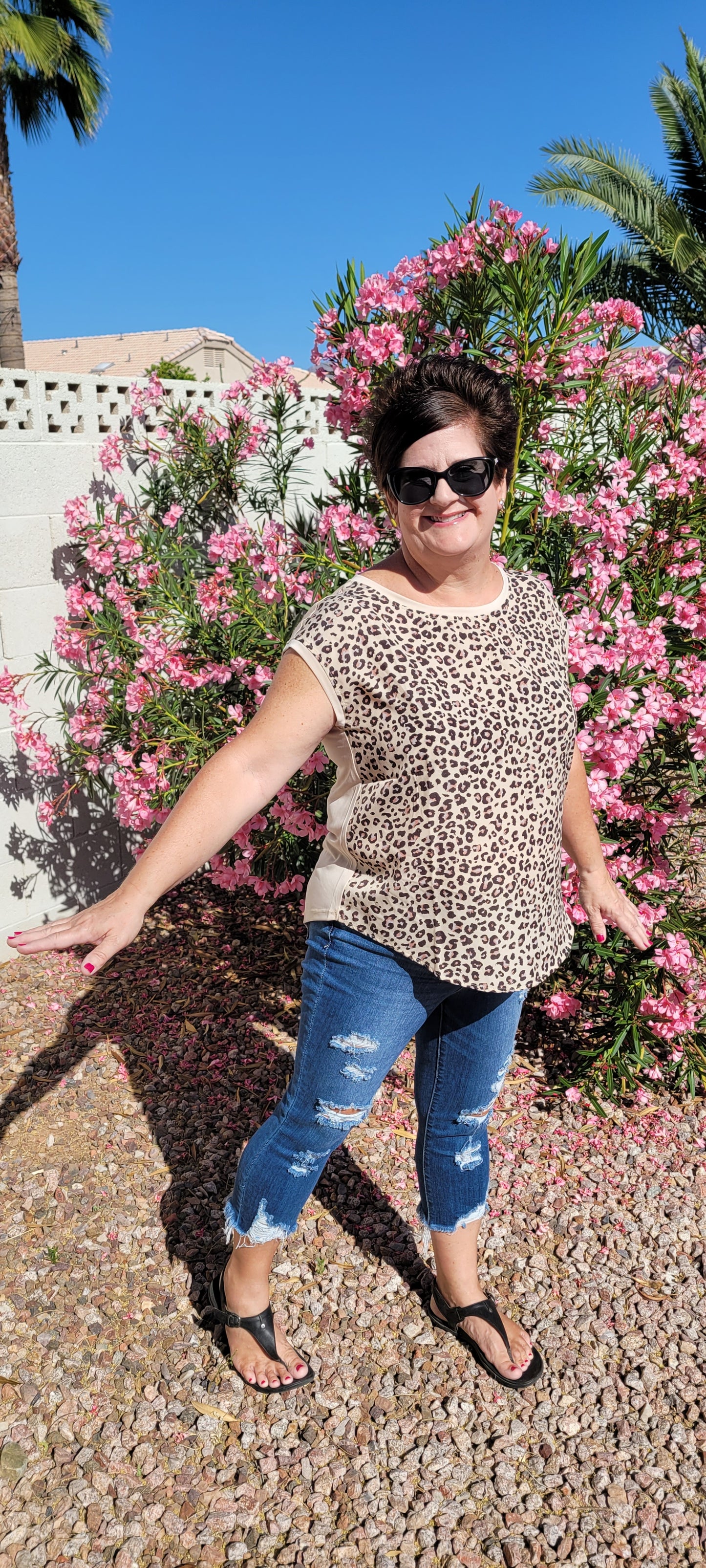 “Road Less Traveled” is a sleeveless top, with leopard print front (beige, brown, camel, agreeable gray) and contrast back, boat neckline, trimmed with beige soft modal, and rounded hemline. This is a satiny, silky soft high-low top. This is definitely a business or casual top. Sizes small through large.
