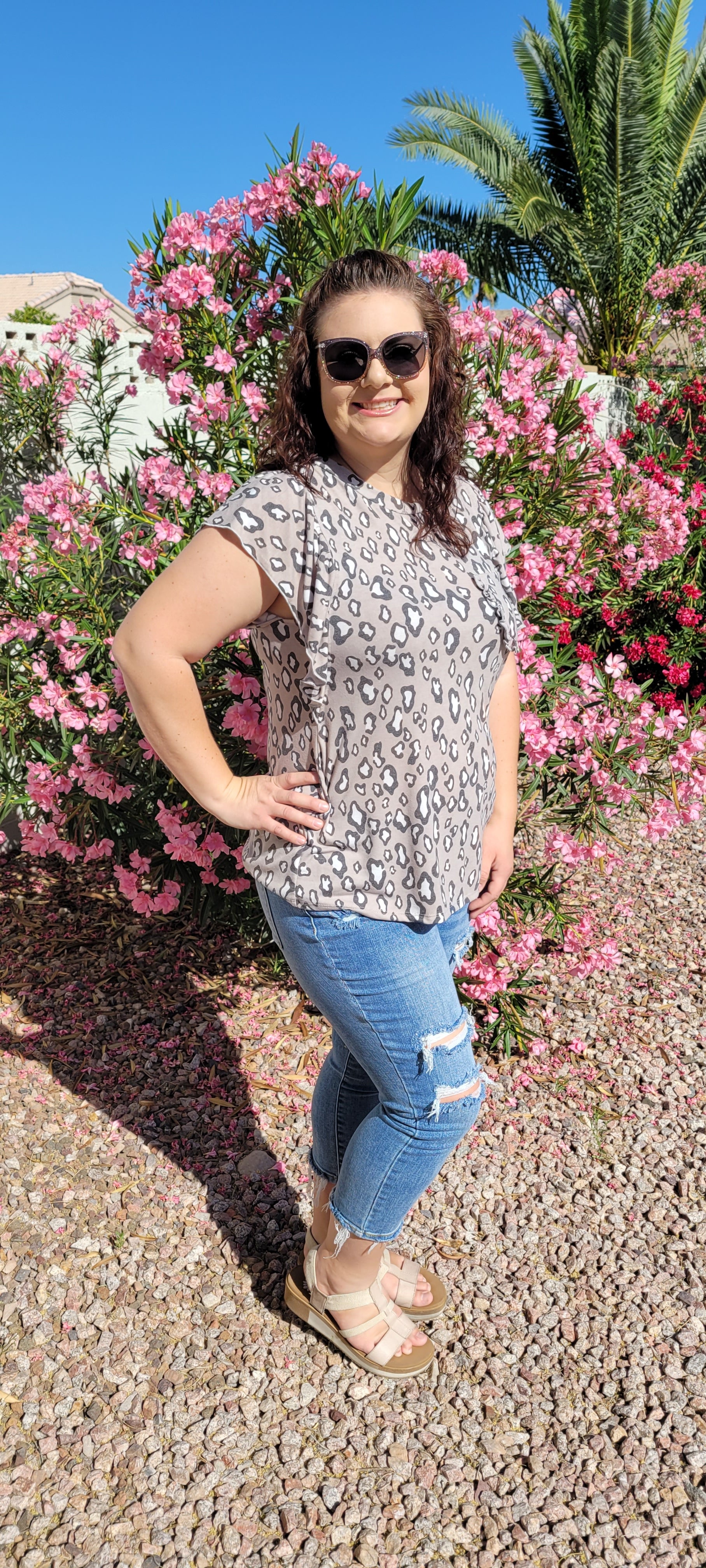 “Fearless” top features a rounded neckline, ruffled short sleeves, ruffled chest pocket, with taupe, white, and gray animal print. This top is great for vacation, those hot summer days, or a shopping day with your friends. Sizes small through large.