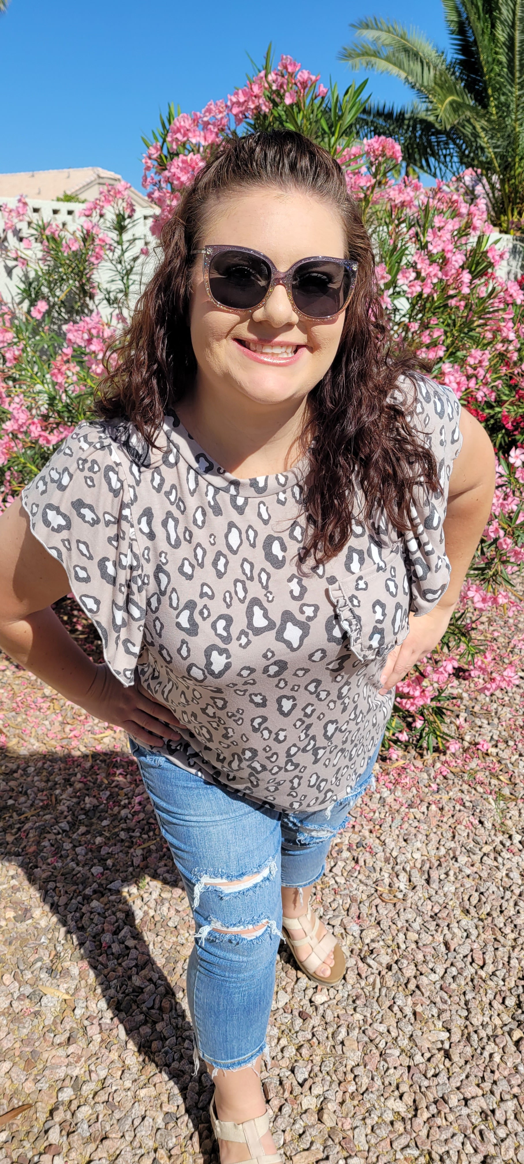 “Fearless” top features a rounded neckline, ruffled short sleeves, ruffled chest pocket, with taupe, white, and gray animal print. This top is great for vacation, those hot summer days, or a shopping day with your friends. Sizes small through large.