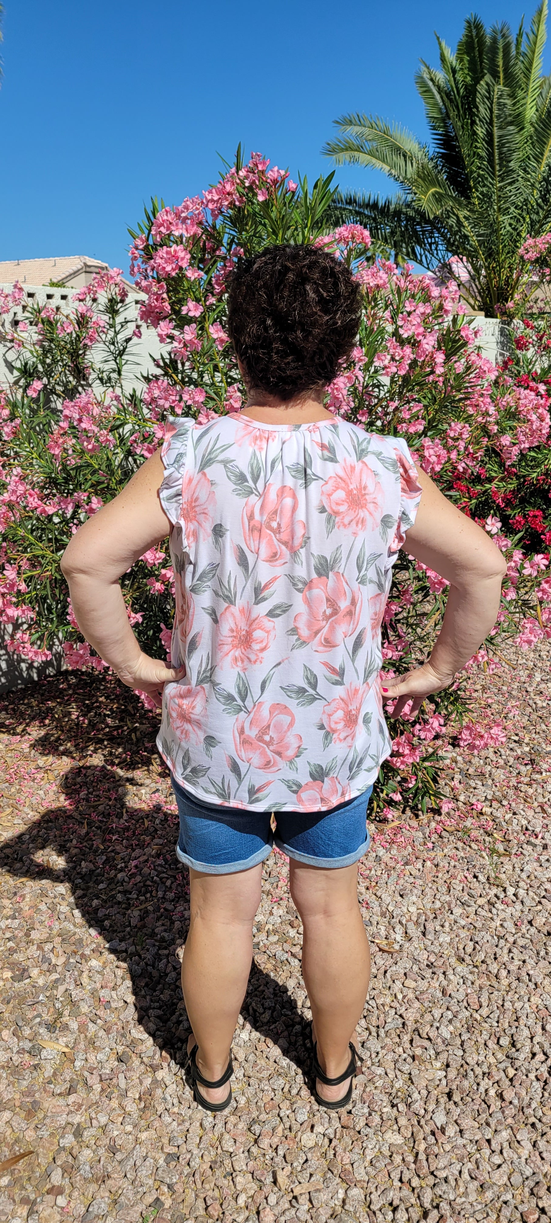 “Garden Goddess” is a comfy and casual top! This sleeveless white shirt features a beautiful pink and sage floral print. It is a baby doll top with rounded neckline, ruffled details on sleeves and chest. This top is so soft and comfy! There is a terry cloth texture inside. Sizes small through large.