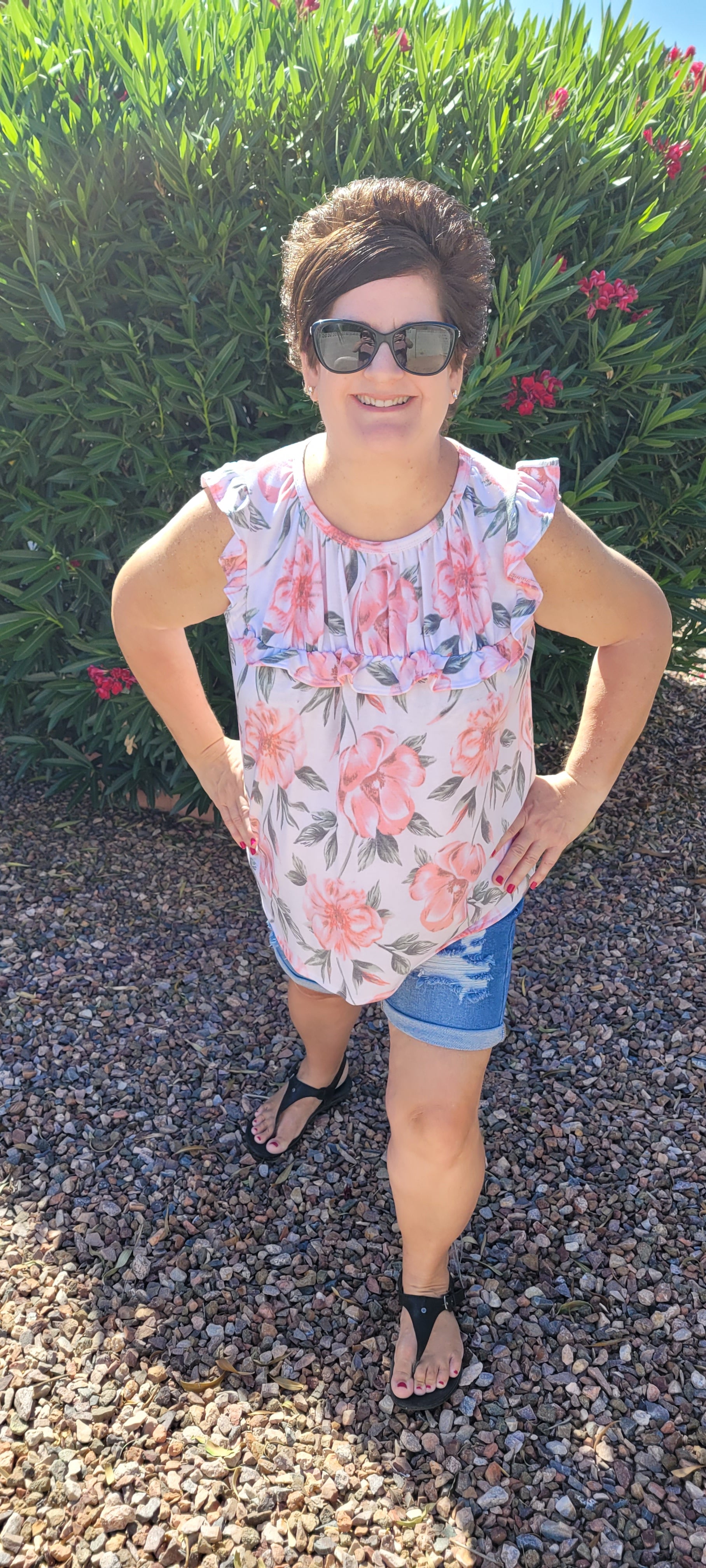“Garden Goddess” is a comfy and casual top! This sleeveless white shirt features a beautiful pink and sage floral print. It is a baby doll top with rounded neckline, ruffled details on sleeves and chest. This top is so soft and comfy! There is a terry cloth texture inside. Sizes small through large.