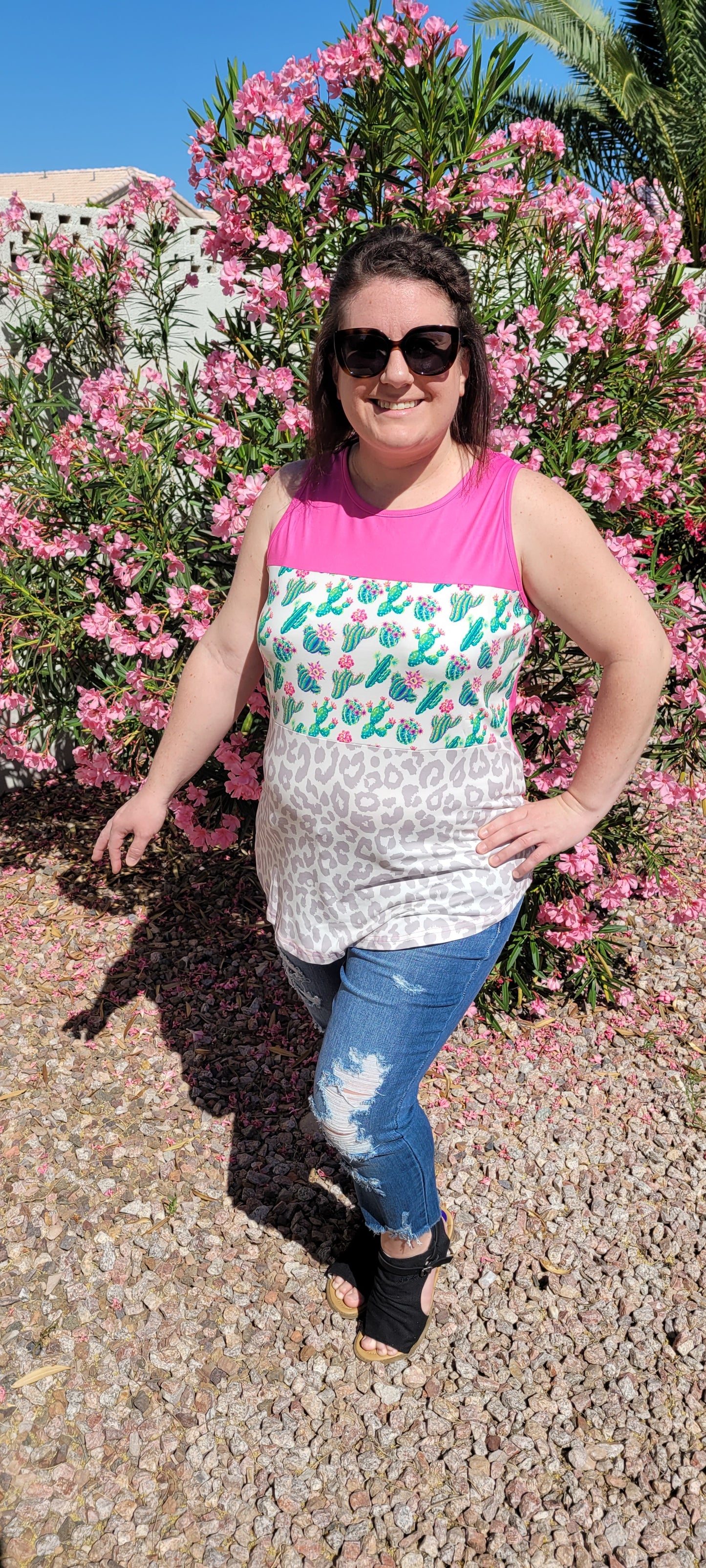 “Don’t Be A Prick” top is a sleeveless tank top, featuring a fuchsia, cactus print, and gray leopard block pattern. It has a solid fuchsia back, scoop neckline, and rounded hemline. This top is buttery soft and has stretch. What a cute summer top! Sizes small through large.