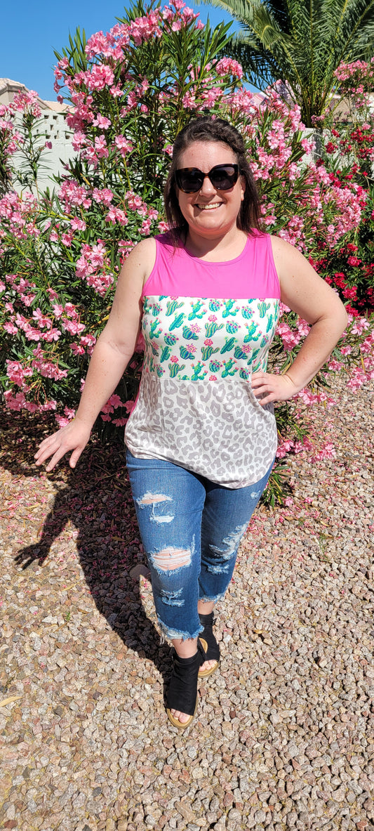 “Don’t Be A Prick” top is a sleeveless tank top, featuring a fuchsia, cactus print, and gray leopard block pattern. It has a solid fuchsia back, scoop neckline, and rounded hemline. This top is buttery soft and has stretch. What a cute summer top! Sizes small through large.