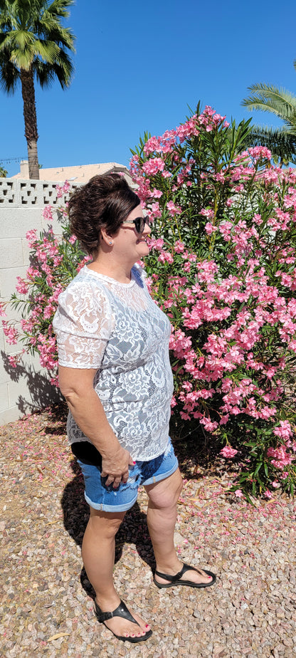 “All About The Lace” is a gorgeous white lace top. This is a short sleeve shirt, featuring floral lace print, bubble sleeves, rounded neckline and hemline. It does have stretch! Pair with your favorite cami or bralette. Sizes small through large.