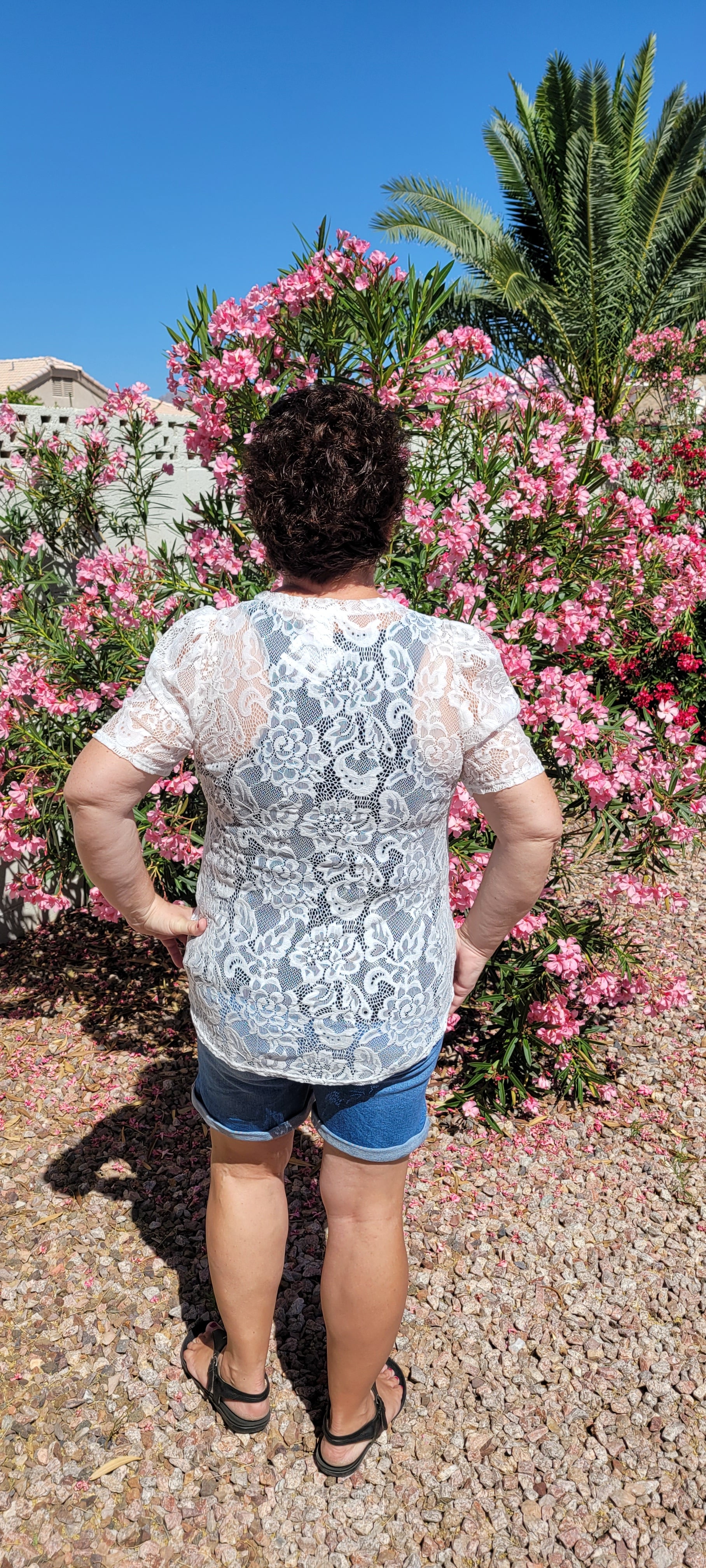 “All About The Lace” is a gorgeous white lace top. This is a short sleeve shirt, featuring floral lace print, bubble sleeves, rounded neckline and hemline. It does have stretch! Pair with your favorite cami or bralette. Sizes small through large.