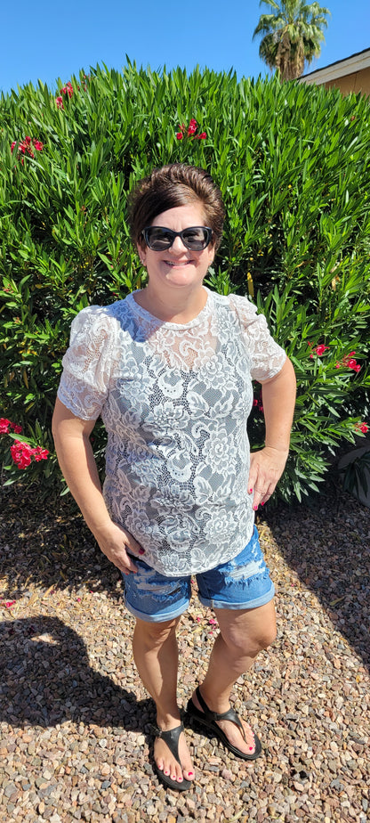 “All About The Lace” is a gorgeous white lace top. This is a short sleeve shirt, featuring floral lace print, bubble sleeves, rounded neckline and hemline. It does have stretch! Pair with your favorite cami or bralette. Sizes small through large.