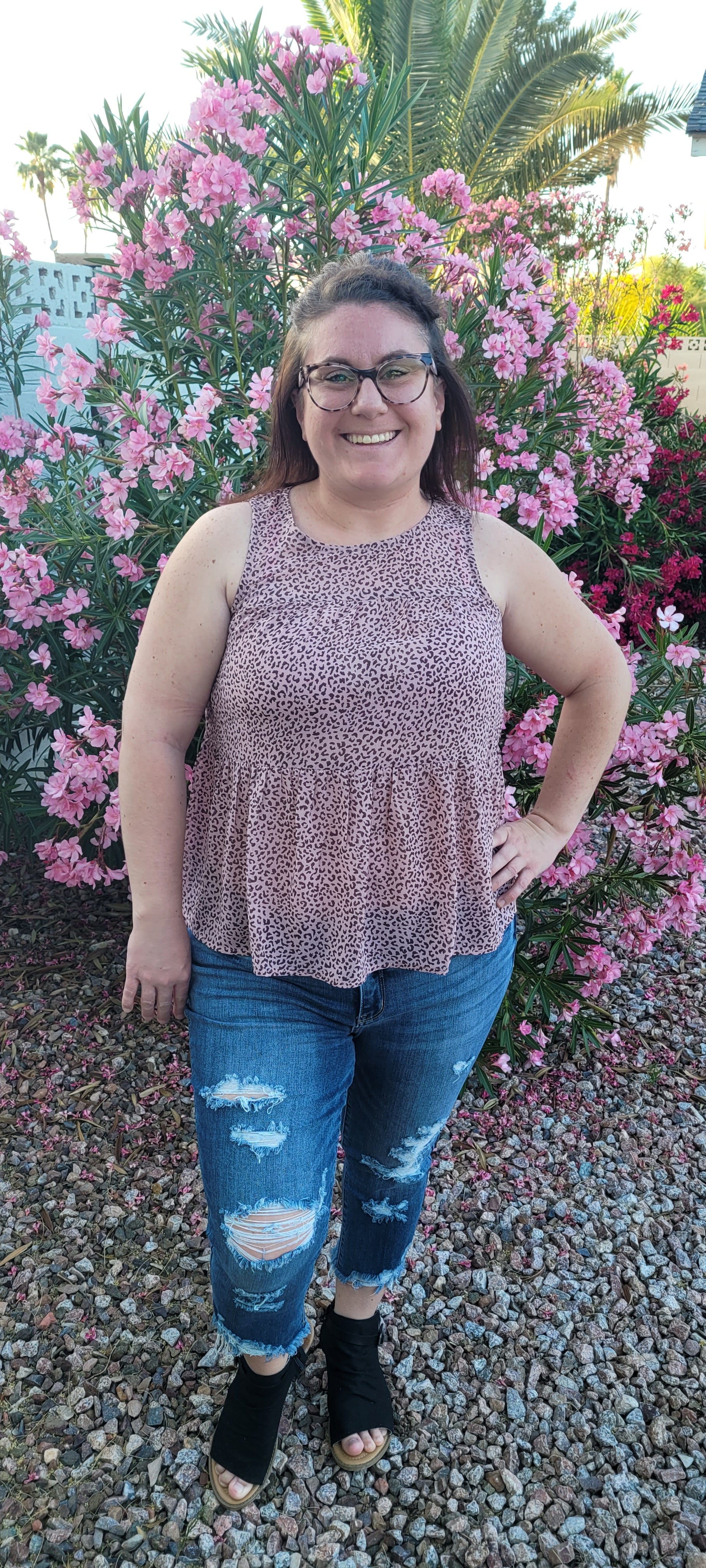 Fancy & Free is a A-line, leopard print, tiered top is sleeveless, flowy and sheer. It features a key hole back with button closure, and has a rounded neckline.  This top is light pink with brown leopard print. It is great for vacation, an evening out, casual event, a day out on the town with your friends, or just because. Sizes small through large.