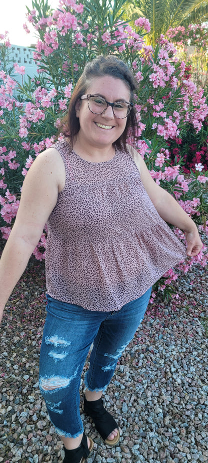 Fancy & Free is a A-line, leopard print, tiered top is sleeveless, flowy and sheer. It features a key hole back with button closure, and has a rounded neckline.  This top is light pink with brown leopard print. It is great for vacation, an evening out, casual event, a day out on the town with your friends, or just because. Sizes small through large.