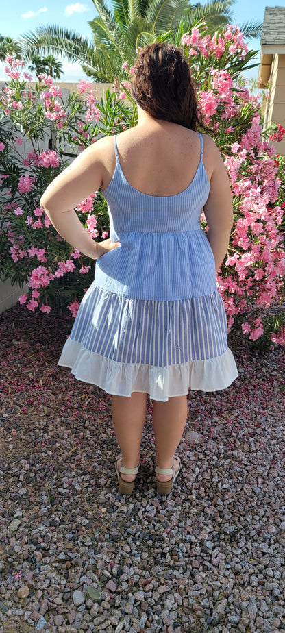 “Beach Hopper” is a midi dress with layers of tiered striped prints. This dress features a white ruffled hemline, adjustable straps, zipper on side with clasp closure, scoop neckline and back, it is lined and does not have stretch. This dress is perfect for a beach getaway! Sizes small through large.