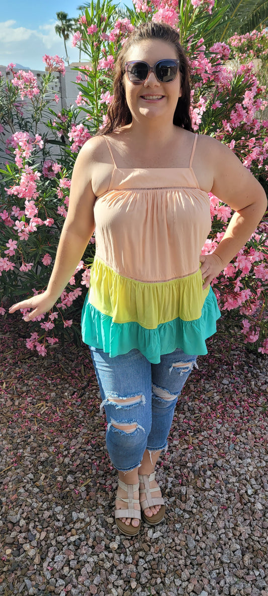 “Tutti Frutti” is a vibrant color block tank top. This tank top features three tiers of color (sherbet orange, lime green, light teal), adjustable straps, elastic back, pleated flare top and cute peekaboo lace trim. This top does not have stretch, but is loose fitting and longer in length. It is super lightweight and breathable. Sizes small through large.