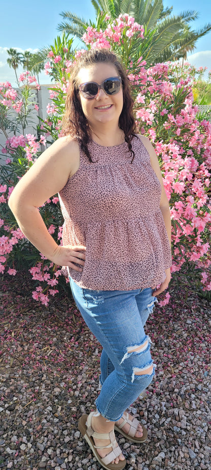 Fancy & Free is a A-line, leopard print, tiered top is sleeveless, flowy and sheer. It features a key hole back with button closure, and has a rounded neckline.  This top is light pink with brown leopard print. It is great for vacation, an evening out, casual event, a day out on the town with your friends, or just because. Sizes small through large.