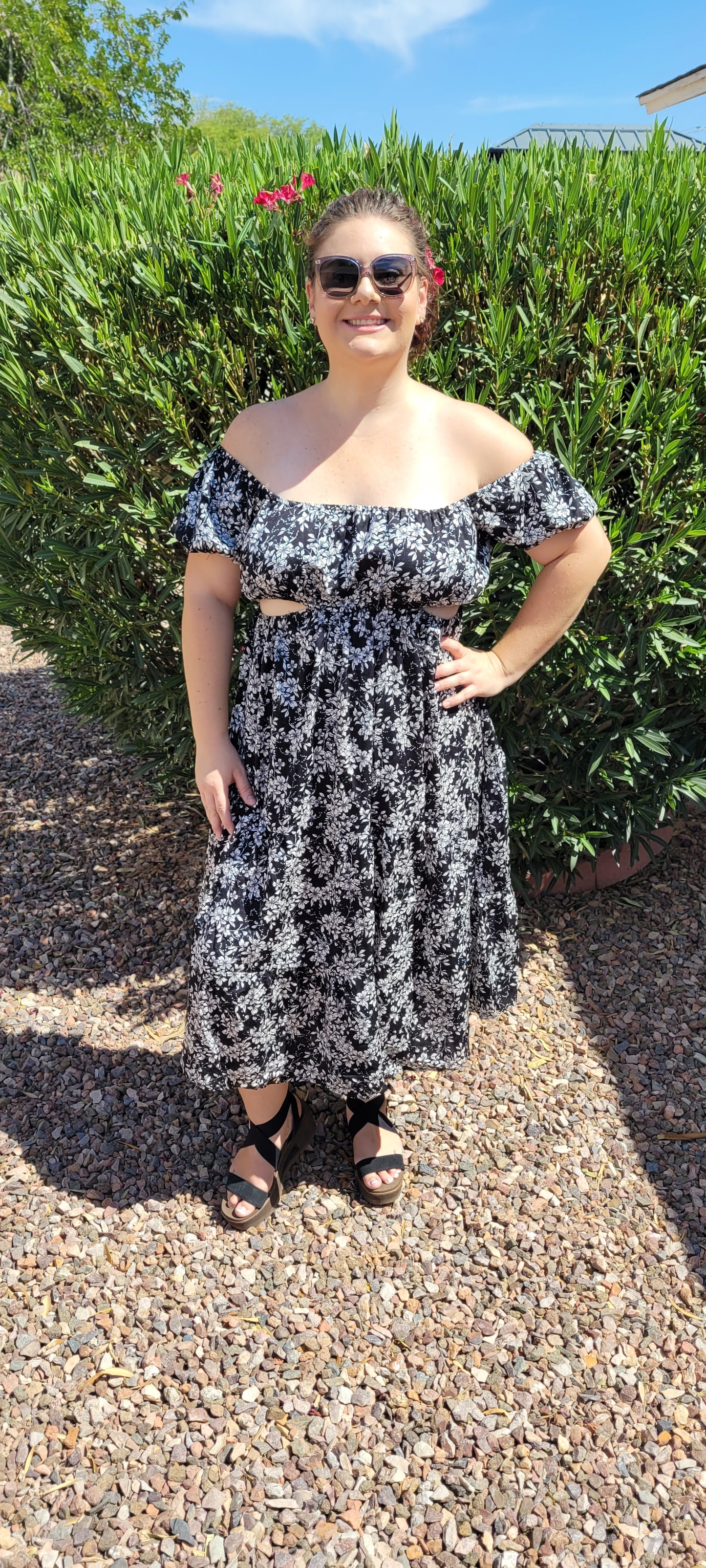 V“Vacay Mode” is a black and white floral dress. This dress features peek-a-boo cutouts, open back with bow tie, tiered hemline, midi length, elastic neckline, puff sleeves, and waistline. This is a woven, non-stretch fabric, unlined, non-sheer, and lightweight. You can wear this dress on or off your shoulders. Sizes small, medium and large