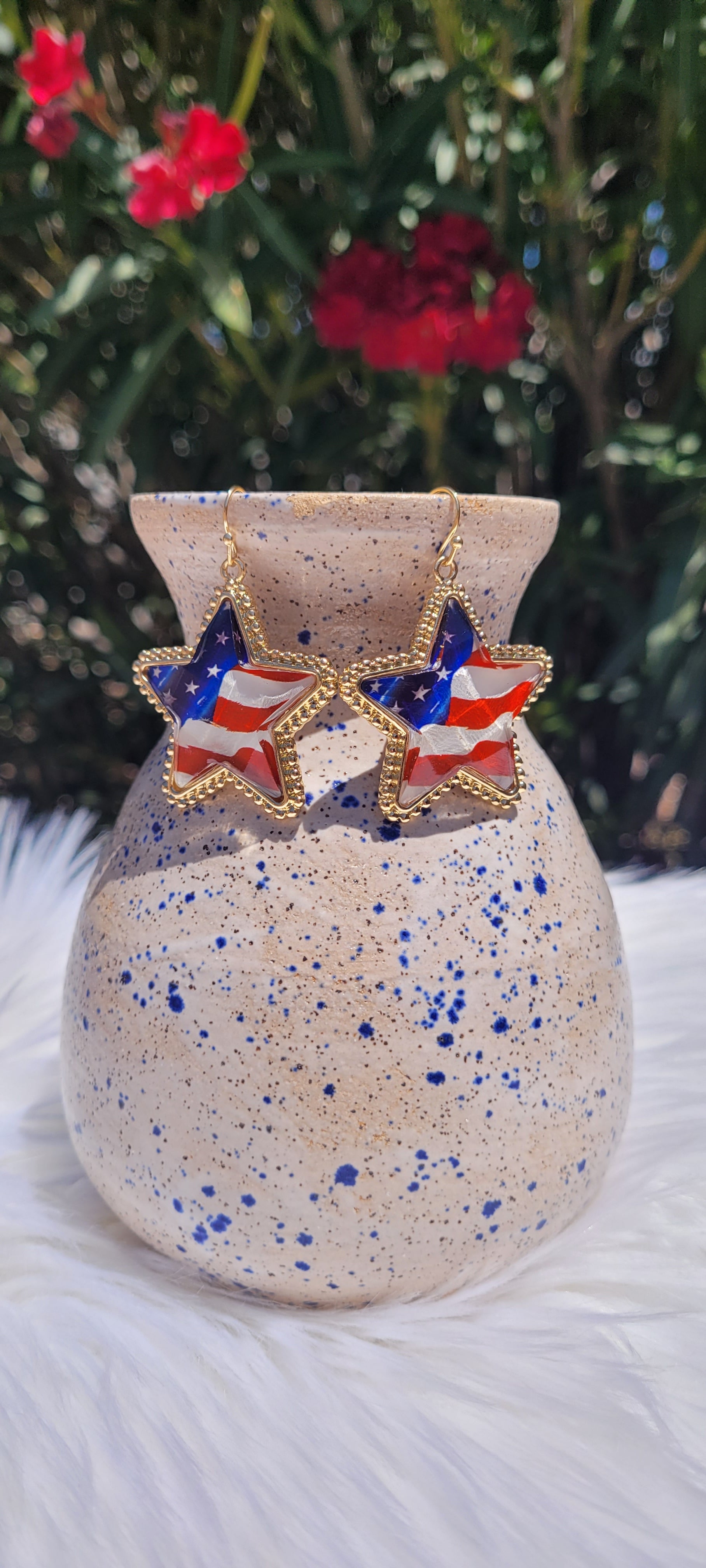 Star shape American flag Brushed gold trim Epoxy material Brushed gold fish hook dangle earrings Rubber earring back Length 1.5” Whether you want to be on the wild side or classy this earring set it will add a fun touch to your outfit