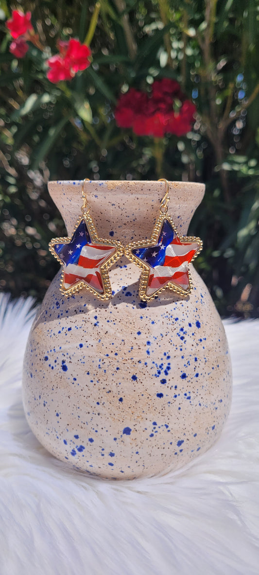 Star shape American flag Brushed gold trim Epoxy material Brushed gold fish hook dangle earrings Rubber earring back Length 1.5” Whether you want to be on the wild side or classy this earring set it will add a fun touch to your outfit