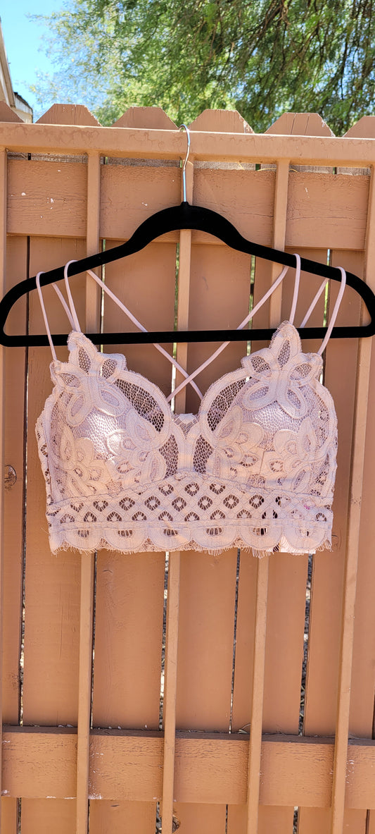 This bralette is a must have staple piece! It is easy for layering or great all by itself! This bralette is super comfy and can easily replace your current bra. No need to worry about clasps, this bralette easily slips over your head. It also features a floral crochet lace, ruched stretchy back, four adjustable straps with crisscross detail in back, and removable bra pads. Color is light mocha. Pair with your favorite jacket or off the shoulder sweater. Don’t be afraid to get creative!
