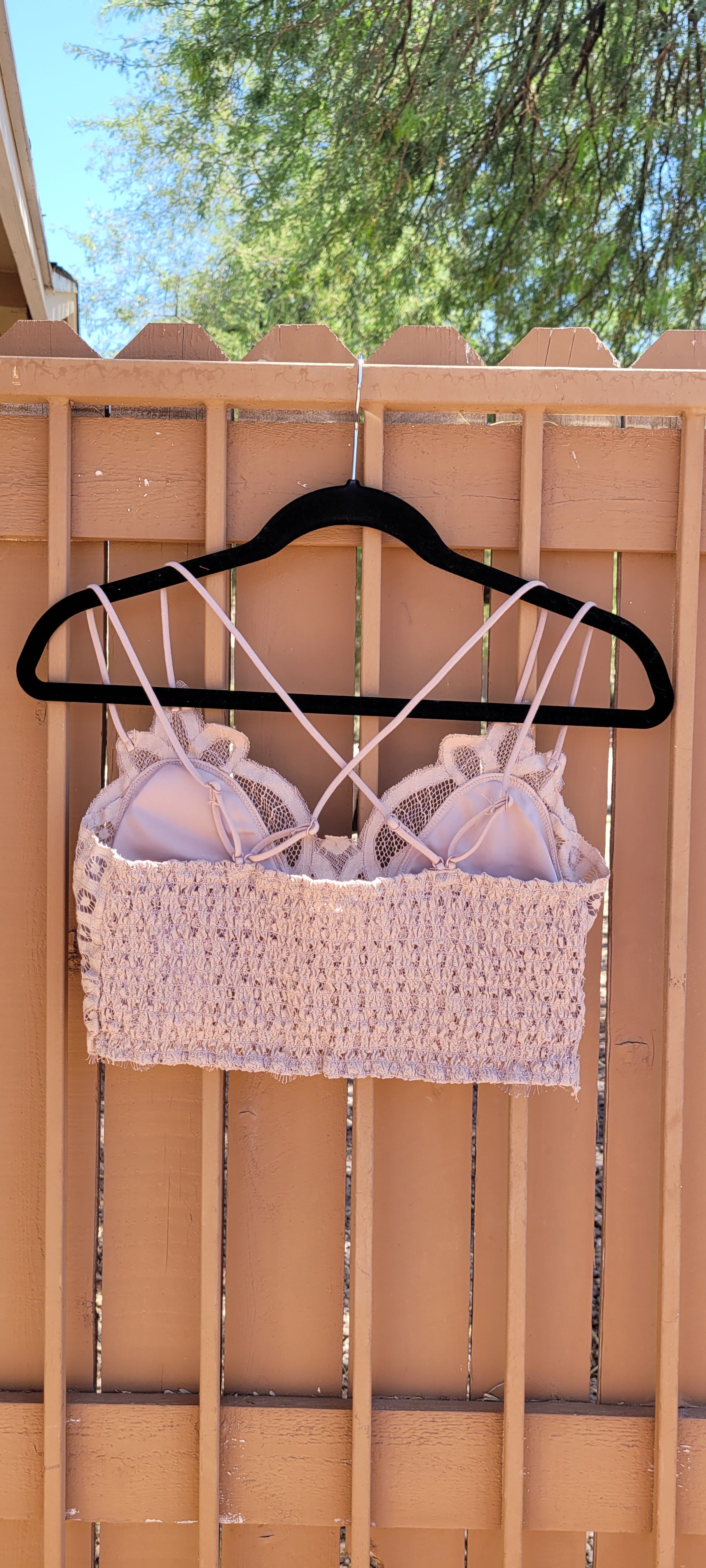 This bralette is a must have staple piece! It is easy for layering or great all by itself! This bralette is super comfy and can easily replace your current bra. No need to worry about clasps, this bralette easily slips over your head. It also features a floral crochet lace, ruched stretchy back, four adjustable straps with crisscross detail in back, and removable bra pads. Color is light mocha. Pair with your favorite jacket or off the shoulder sweater. Don’t be afraid to get creative!