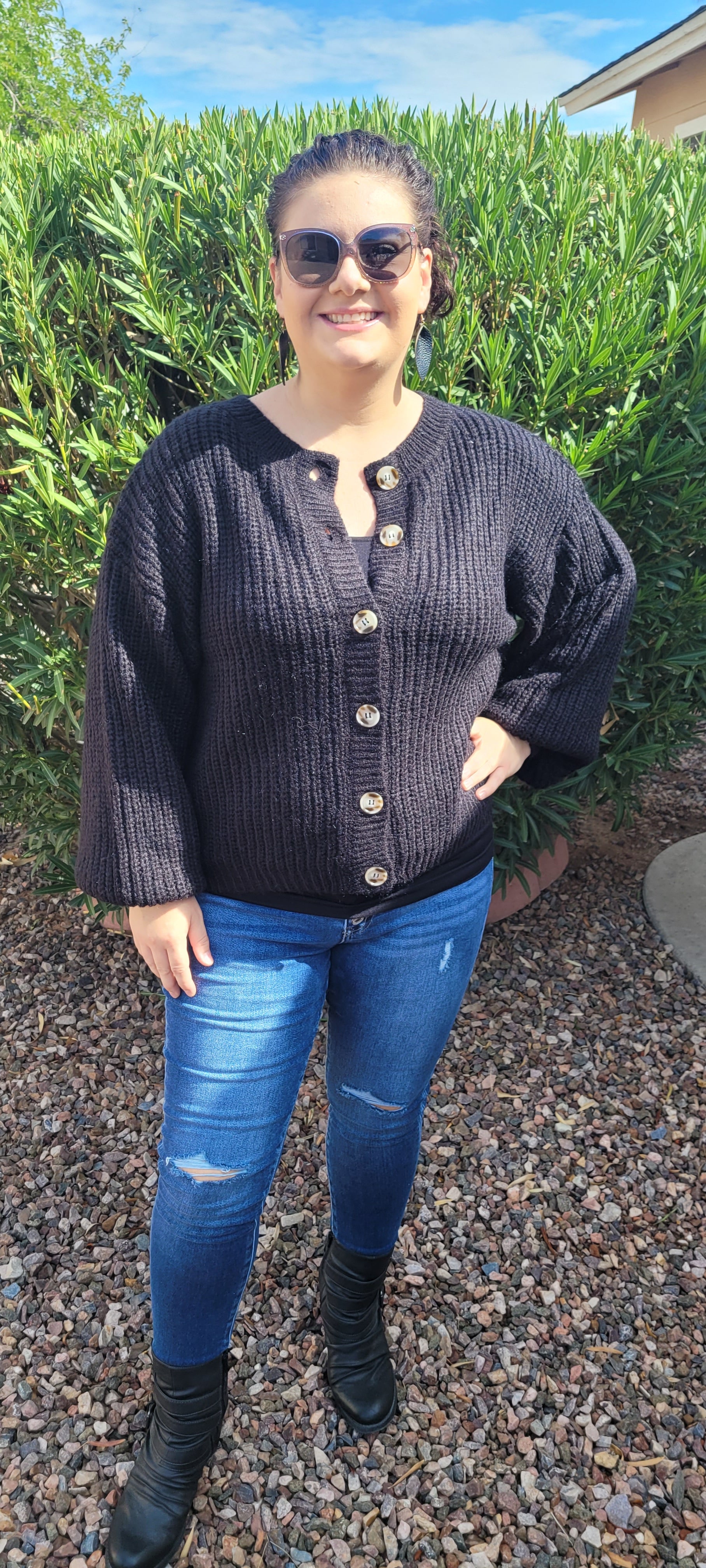 Who says you can’t look fabulous in a basic black sweater! This black cardigan features a button down front with balloon sleeves, and cinched cuffs and hemline. Nice thick sweater material, you will be sure to stay warm. This sweater is very versatile, and can be dressed up, worn to the office, or everyday use. Sizes small through x-large.