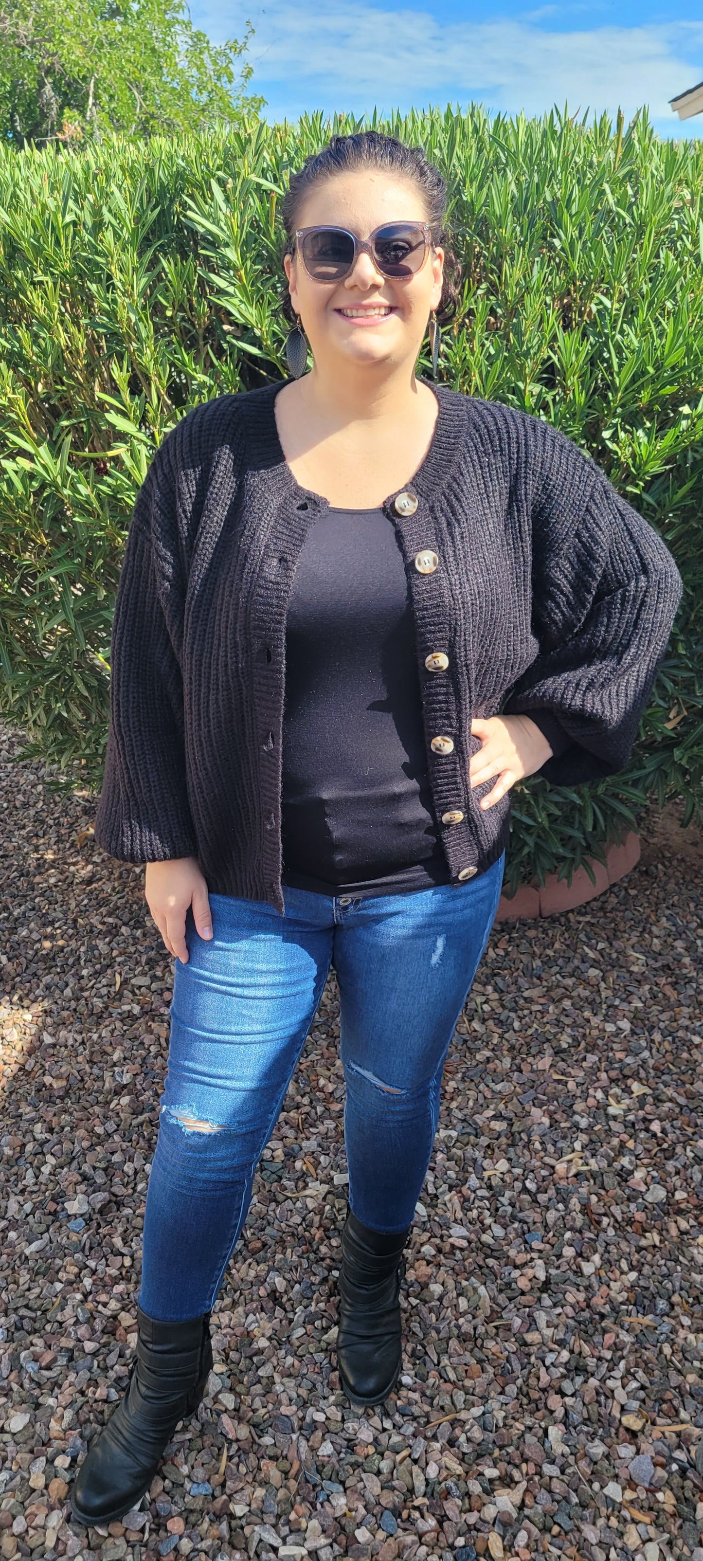 Who says you can’t look fabulous in a basic black sweater! This black cardigan features a button down front with balloon sleeves, and cinched cuffs and hemline. Nice thick sweater material, you will be sure to stay warm. This sweater is very versatile, and can be dressed up, worn to the office, or everyday use. Sizes small through x-large.