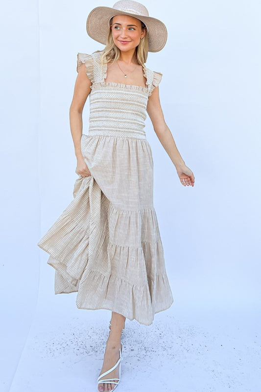 The Linen Striped Ruffle Dress is a breezy and feminine choice for the summer months. The linen fabric makes it lightweight and comfortable for warm weather wear. The striped pattern adds a classic touch to the dress, while the ruffle detailing brings a playful element to the design.  S - L