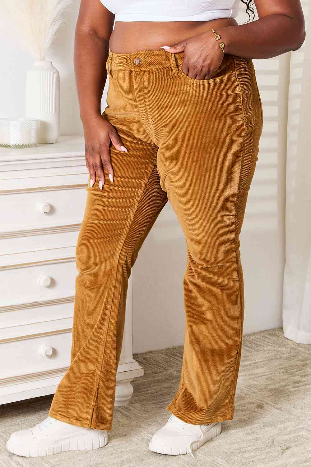 These pants feature a mid-rise waist that flatters your silhouette while providing a comfortable fit. The rich camel color is achieved through a unique overdyed process, ensuring a vibrant and lasting hue. The classic bootcut design adds a touch of timeless elegance, making these pants versatile for both casual and semi-formal occasions.   