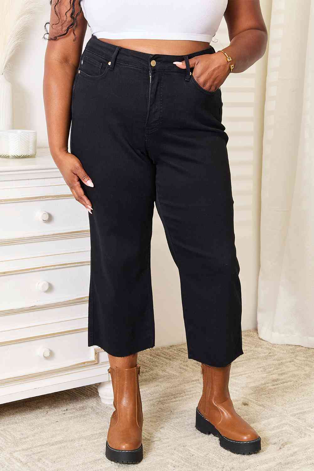 These jeans are a must-have addition to your wardrobe, offering a sleek and sophisticated look with their high waisted design that accentuates your curves. The cropped wide leg adds a touch of flair and versatility, allowing you to pair them effortlessly with both casual and formal outfits. What sets these jeans apart is their clean, no-distressing finish, making them a chic choice for any occasion.