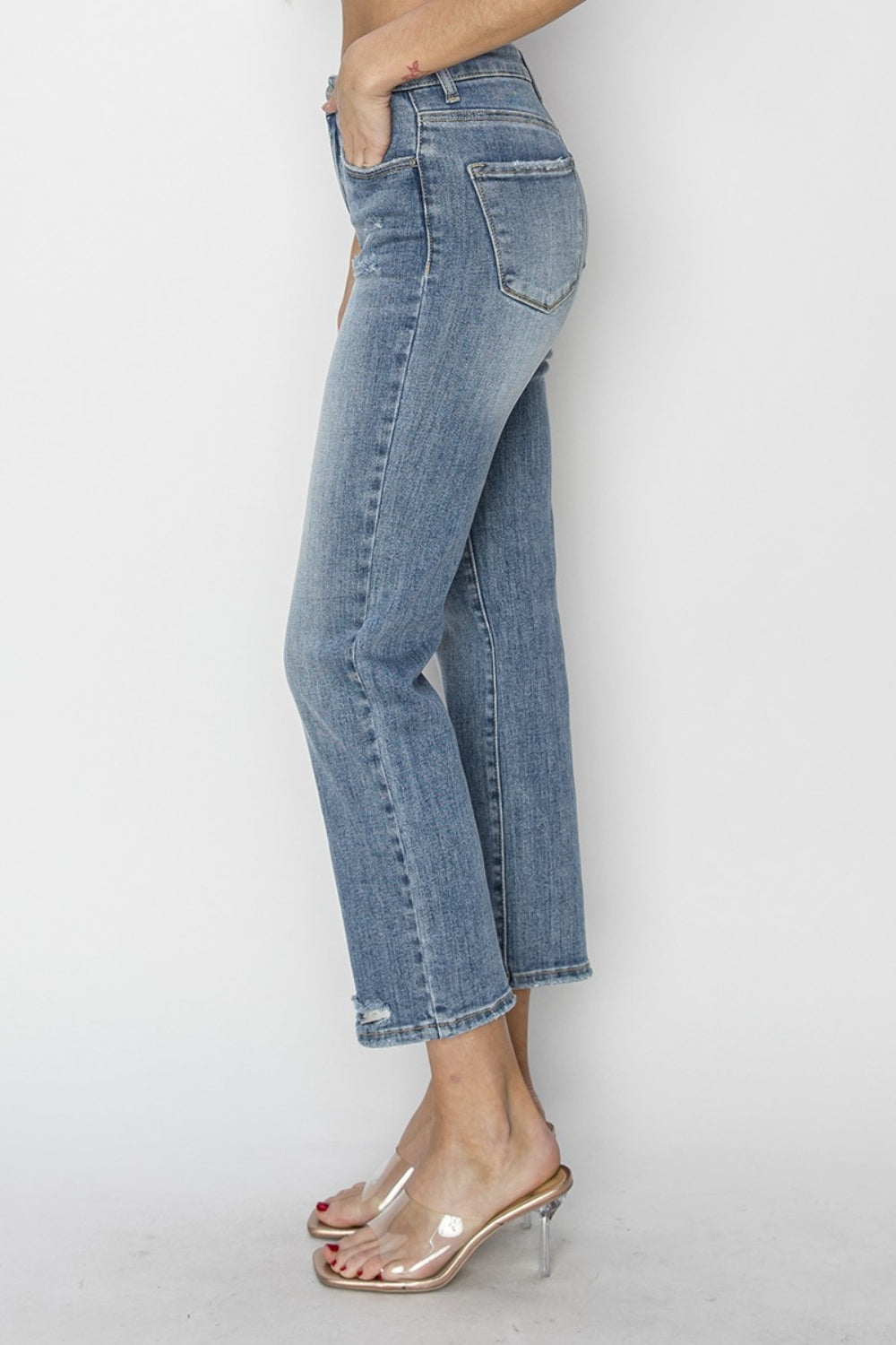 The High Waist Distressed Cropped Jeans are a trendy and edgy addition to your denim collection. The high waist design offers a flattering and on-trend silhouette. The distressed detailing adds a cool and rugged vibe to the cropped jeans. 