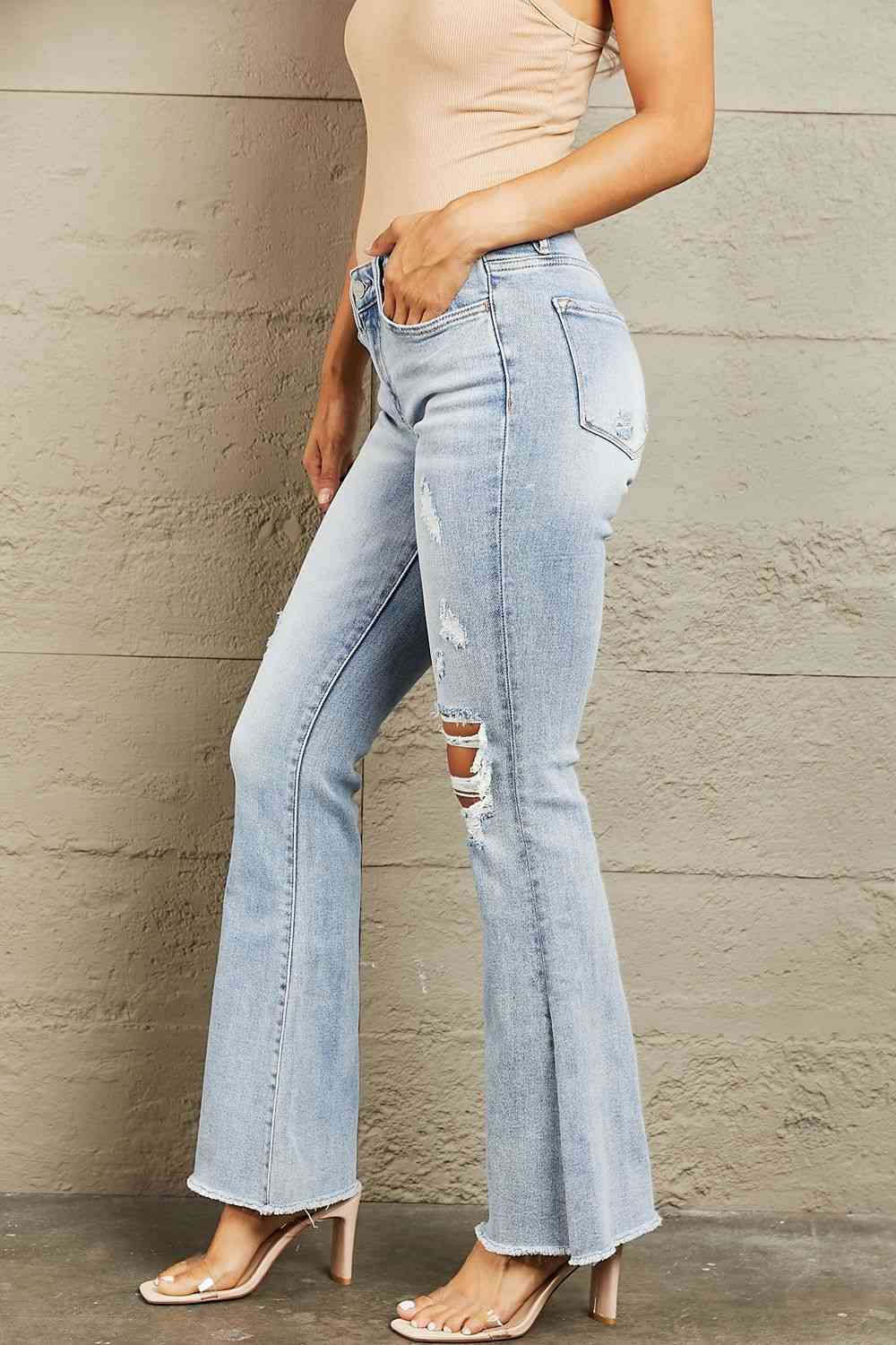 These jeans feature expert distressing that adds a worn-in appeal, giving you a perfectly lived-in look. The flattering mid-rise waist offers a comfortable fit, while the flared leg adds a trendy, retro vibe to any outfit. 